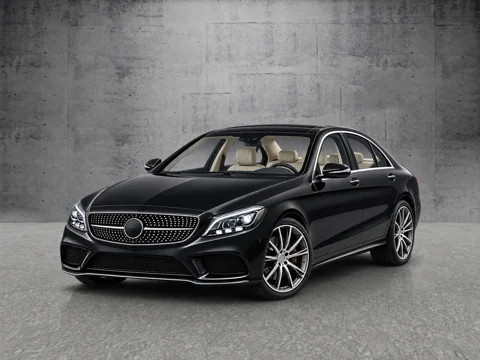 Black sedan in concrete wall setting