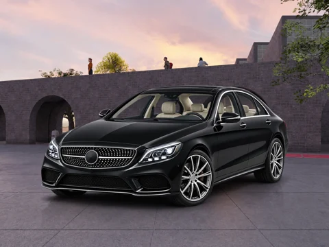 Black sedan in courtyard at dusk setting