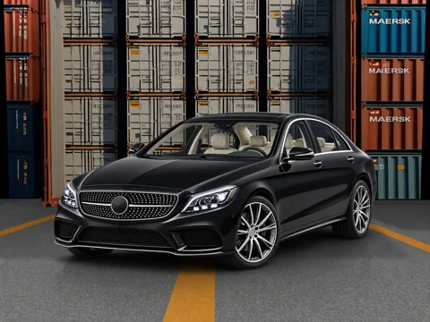 Black sedan in freight depot setting