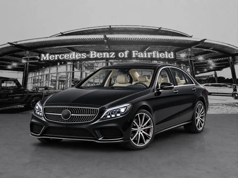 Black sedan in dealer forecourt setting