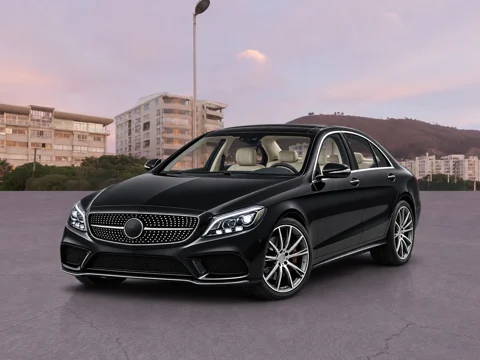 Black sedan in urban sunset setting