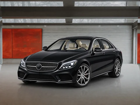 Black sedan in red door studio setting