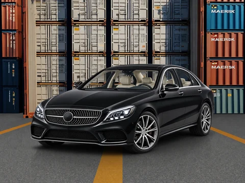 Black sedan in shipping yard setting