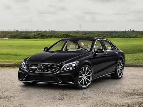 Black sedan in country field setting