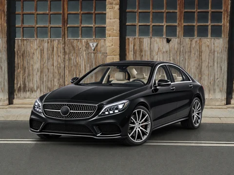 Black sedan in factory facade setting